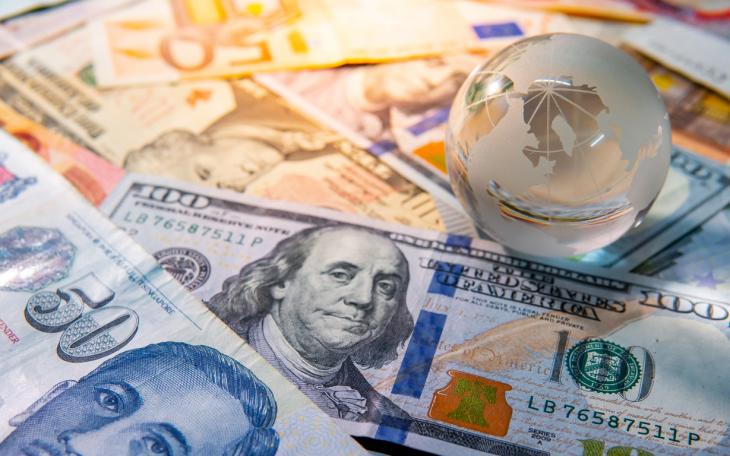 World globe crystal on various banknotes