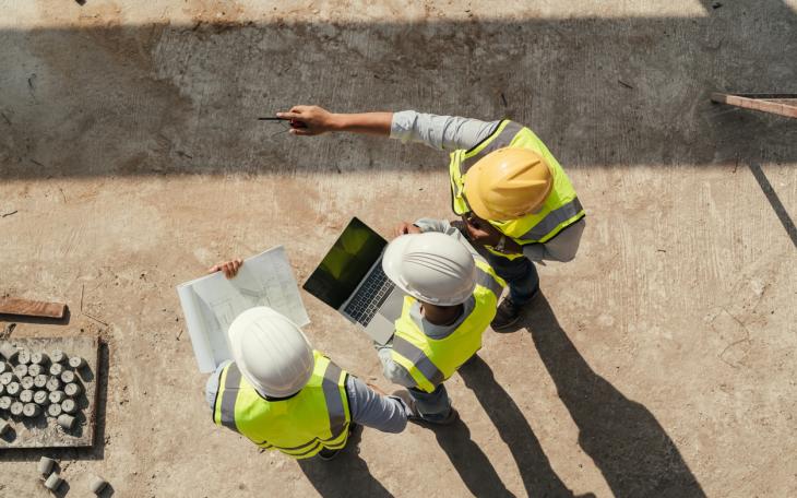 builders surveying site