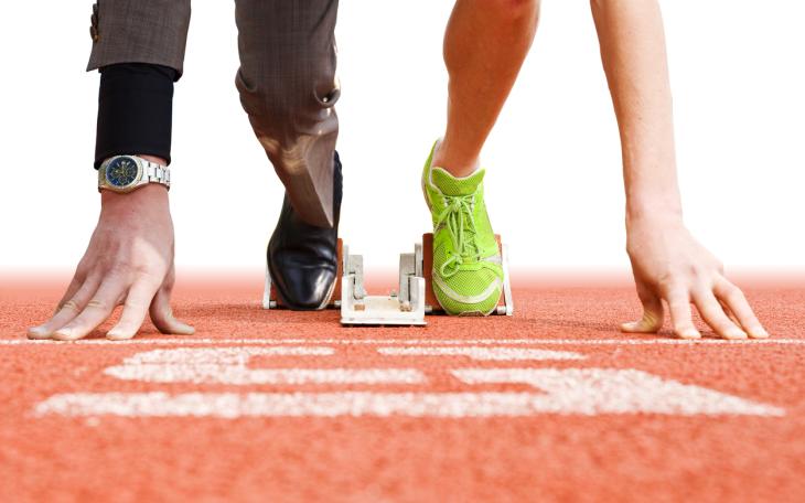  runner on a start line half in smart attire half in sports attire