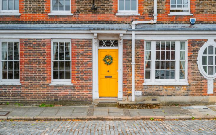 property London house with yellow door and wreath