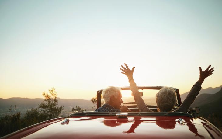 Pensions_older couple in convertible red car