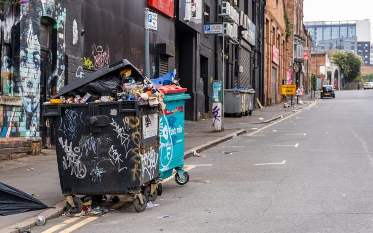 graffiti'd bins overflow on a London road 