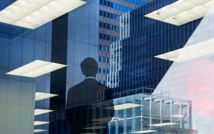 corporate abstract with businessman looking out