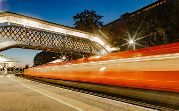 train flashing by a station