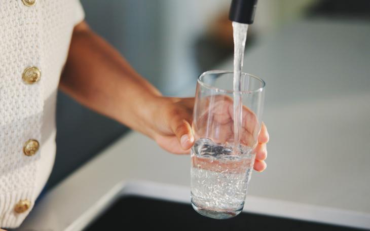 water coming out of tap into glass