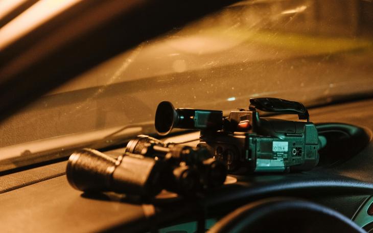 camera and binoculars on dashboard