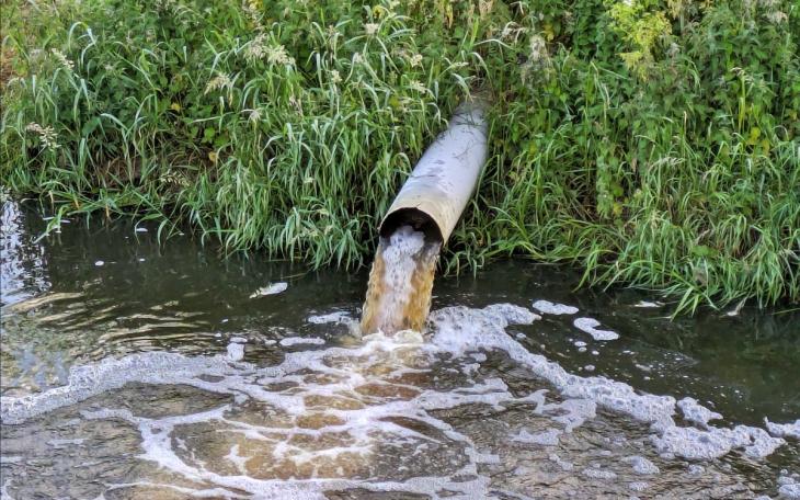 water sewage into stream