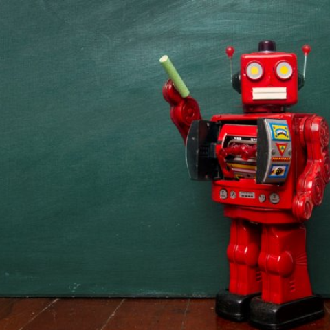 red robot teach pointing to classroom chalkboard with green chalk