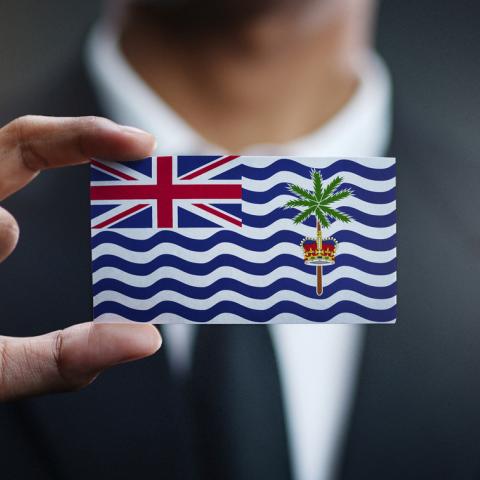 man holding small chagos flag