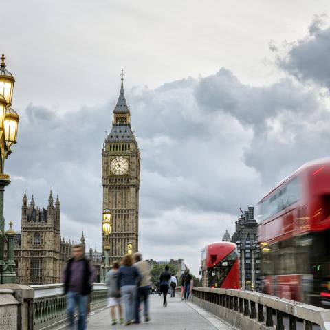 Westminster, red bus and pedestrians