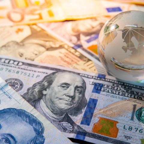 World globe crystal on various banknotes