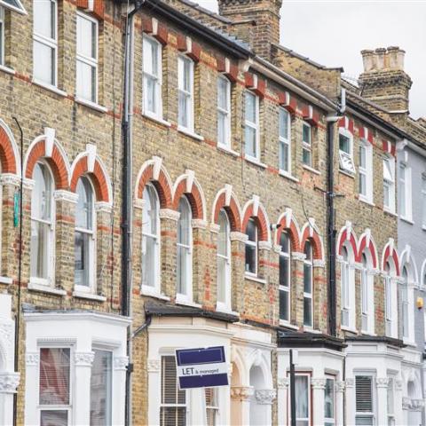 Row of victorian housing with rental boards