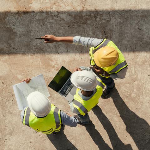 builders surveying site