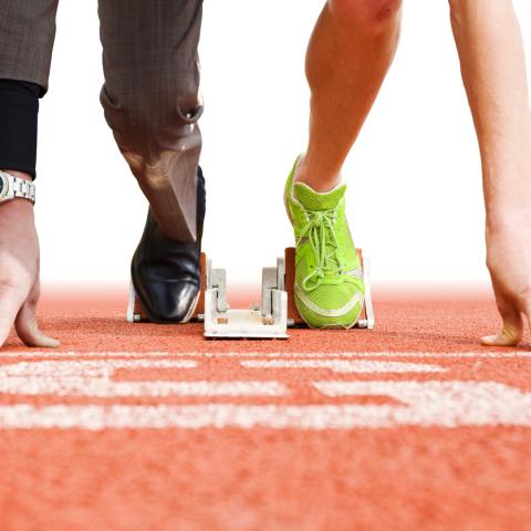   runner on a start line half in smart attire half in sports attire