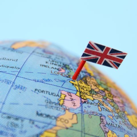 globe with union jack flag pinned on UK