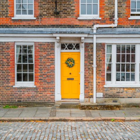 property London house with yellow door and wreath