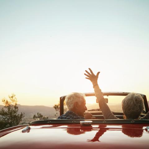 Pensions_older couple in convertible red car