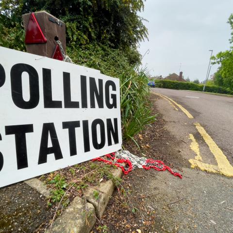 polling station sign on road