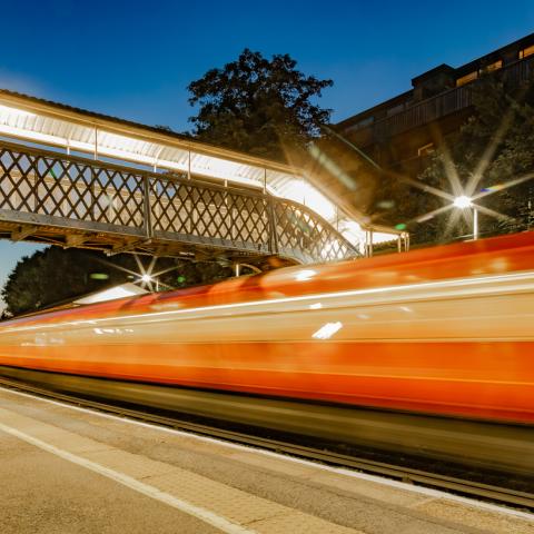 train flashing by a station