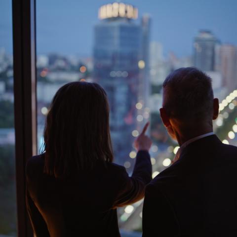 real estate developers pointing outside window