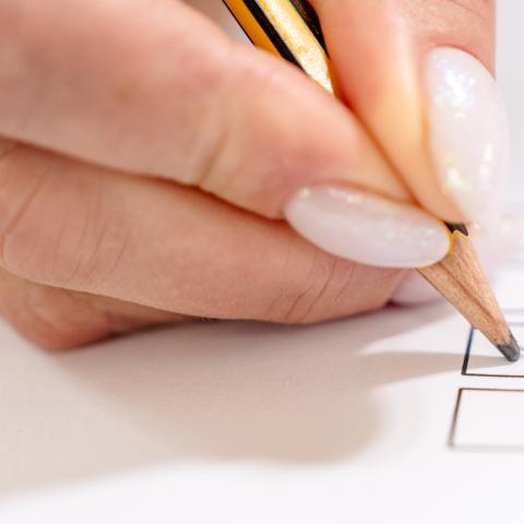 pen writing on ballot box