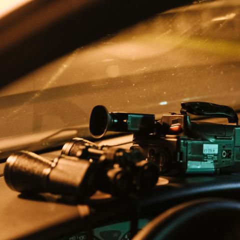 camera and binoculars on dashboard